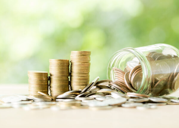 Coin on wooden table in front of green bokeh background. coins a concept of investment and saving moneys.