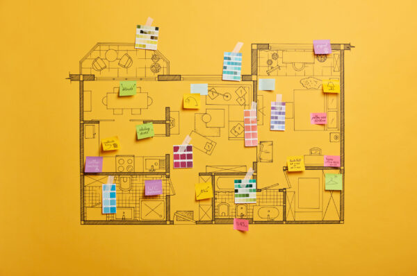 Home renovation and design concept. House scheme of different rooms. Furnishing project. Sticky notes with written information, yellow background. Architectural plan of house with color palette