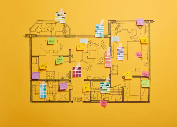 Home renovation and design concept. House scheme of different rooms. Furnishing project. Sticky notes with written information, yellow background. Architectural plan of house with color palette