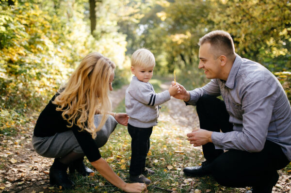 happy family playing and laughing in autumn park