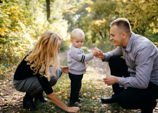 happy family playing and laughing in autumn park