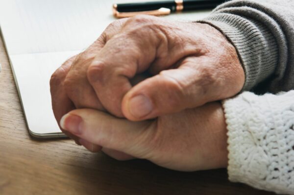 Senior married coupple comforting each other and holding hands