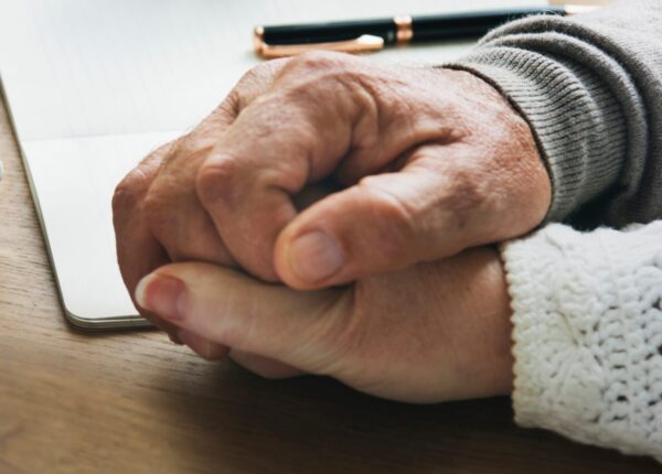 Senior married coupple comforting each other and holding hands